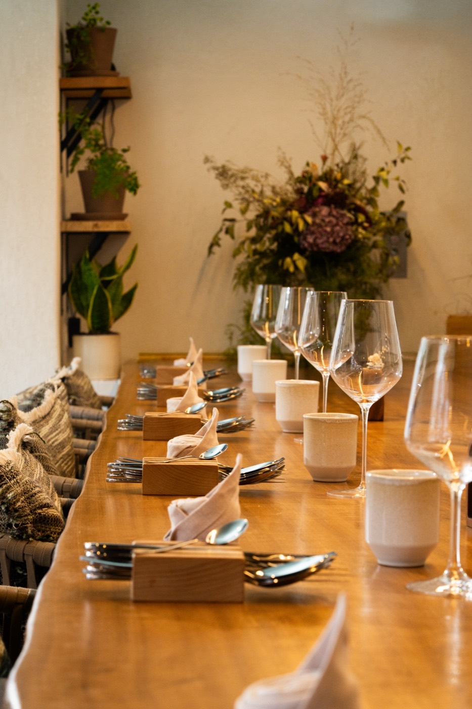 The counter set with flowers and cutlery, ready for service